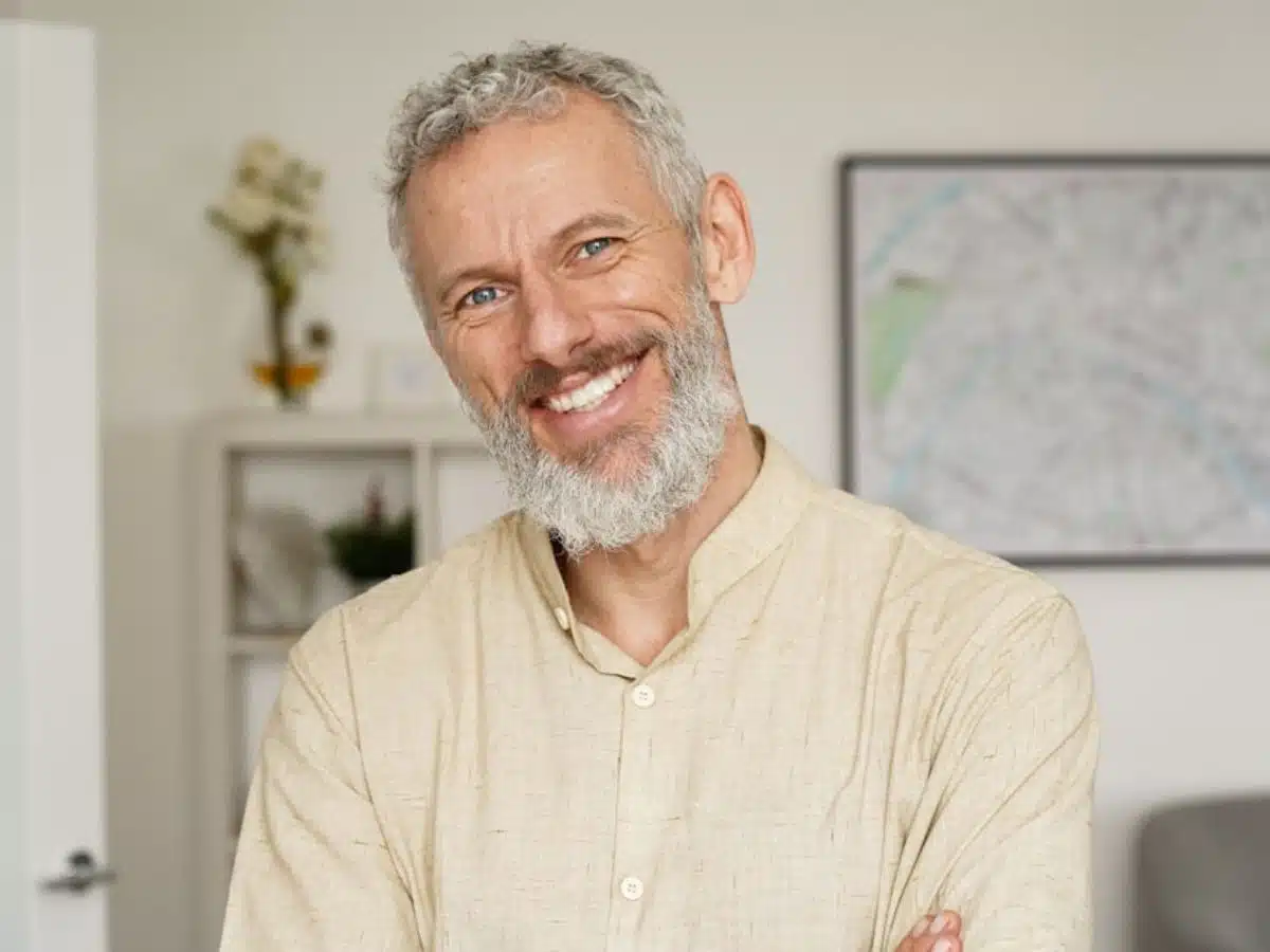 man in white shirt smiling with teeth